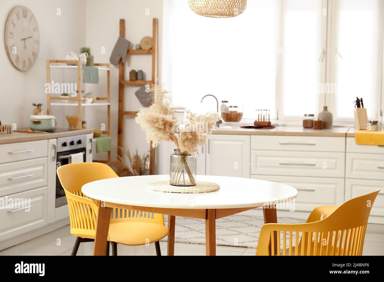Dining table with chairs in modern interior of kitchen Stock Photo - Alamy
