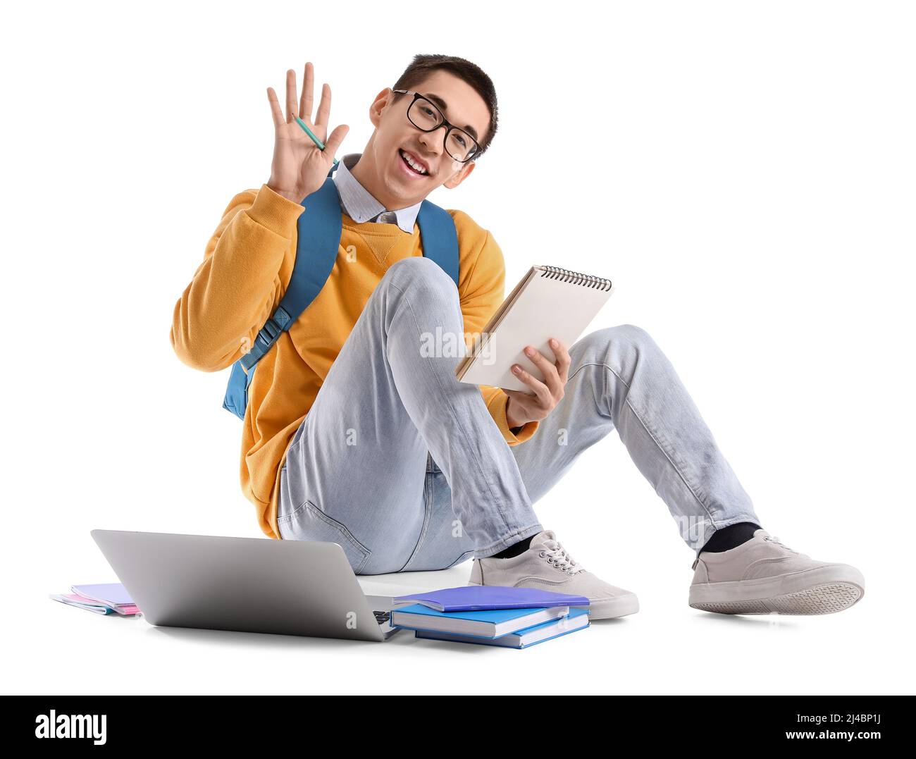 Male Asian student with notebook waving hand on white background Stock ...
