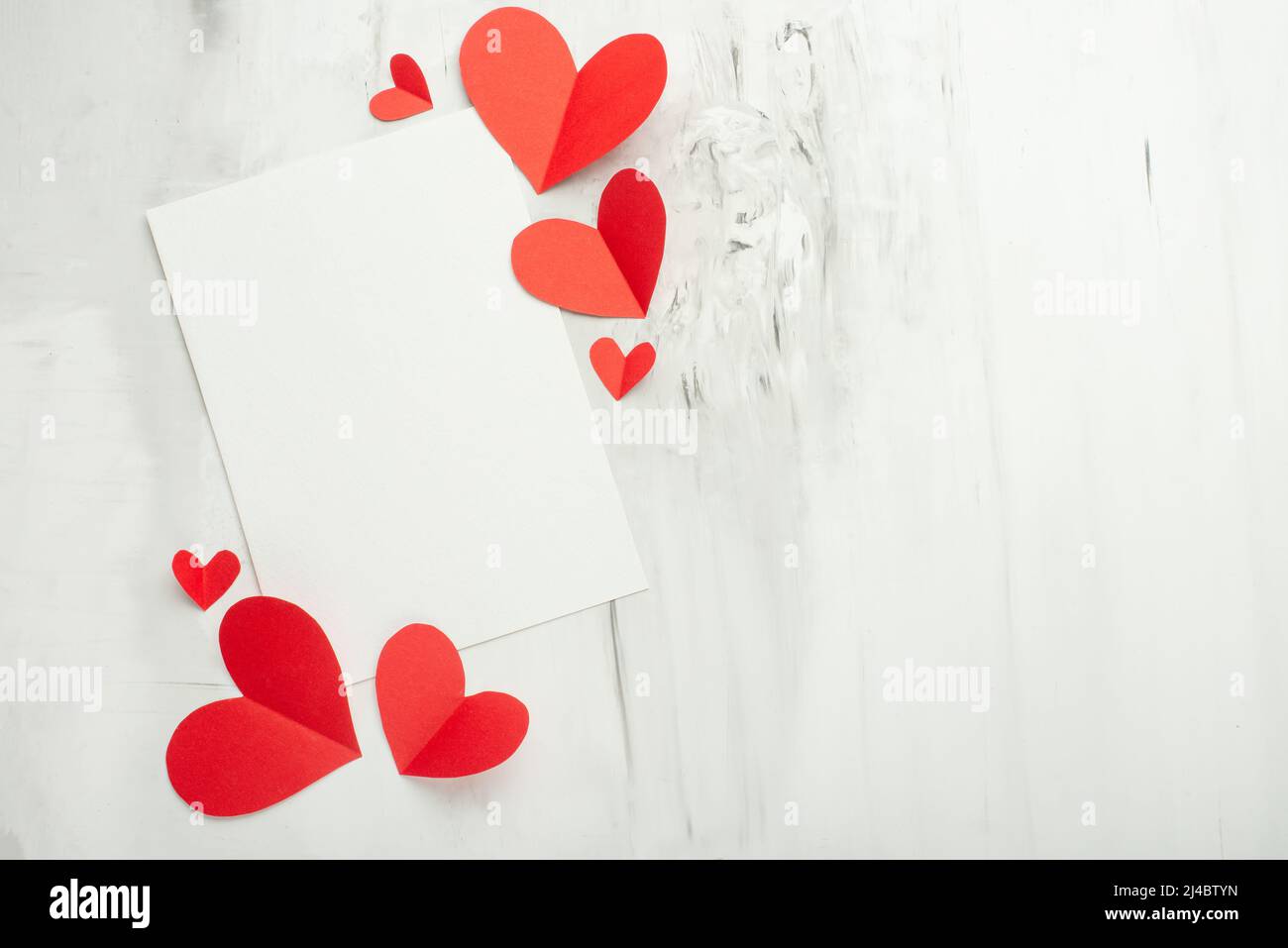 Valentine background with red hearts and white postcard for design on a ...