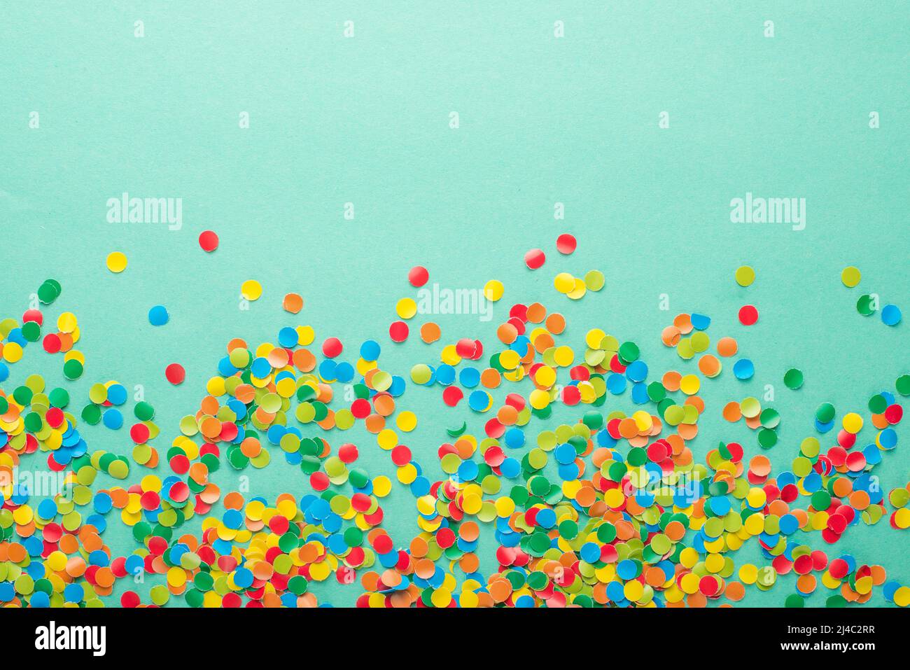 Colorful Confetti in front of blue Background Stock Photo - Alamy