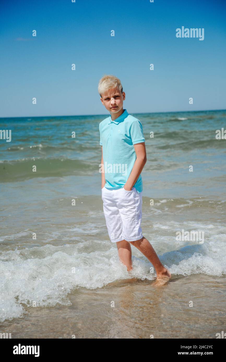 Boy in cozy beige clothes applying sunscreen protection creme on his face.  Sun protection during summer sea vacation. Children healthcare at travel t  Stock Photo - Alamy