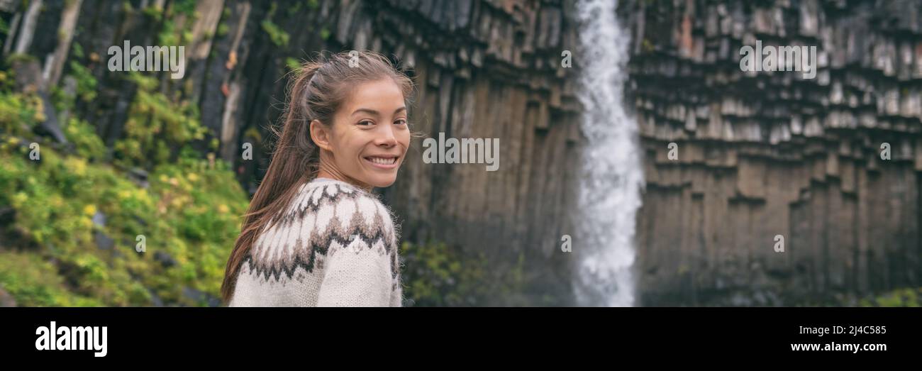 Woman portrait on Iceland. Hiker by Svartifoss waterfall visiting famous tourist attraction of Iceland. Natural landmark on vacation in Skaftafell Stock Photo