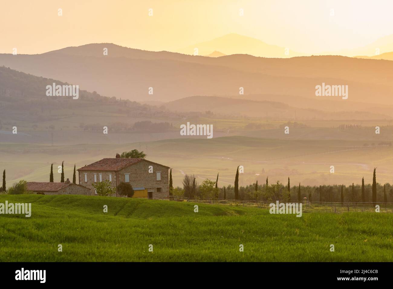 Old farmhouse on a field at a valley in the sunset Stock Photo - Alamy