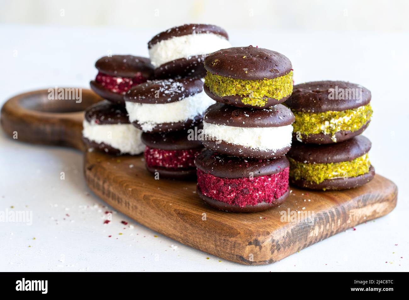 Chocolate biscuit with milk filling. Cake with milk filling on a white background. Chocolate-milk kids dessert. Bakery products. Close-up. local name Stock Photo