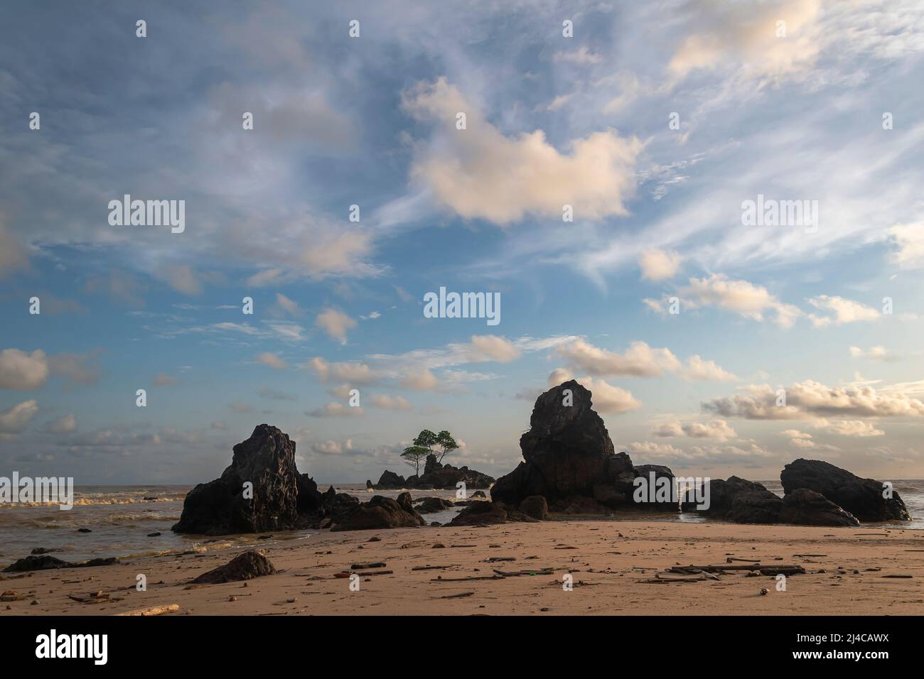 Sunset over Ghana West Africa's seas and rocks in silhouette Stock Photo
