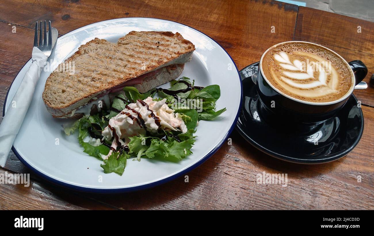 CARDIFF. CAERDYDD; WALES; 08-11-21. A toasted cheese sandwich and latte coffee. Stock Photo