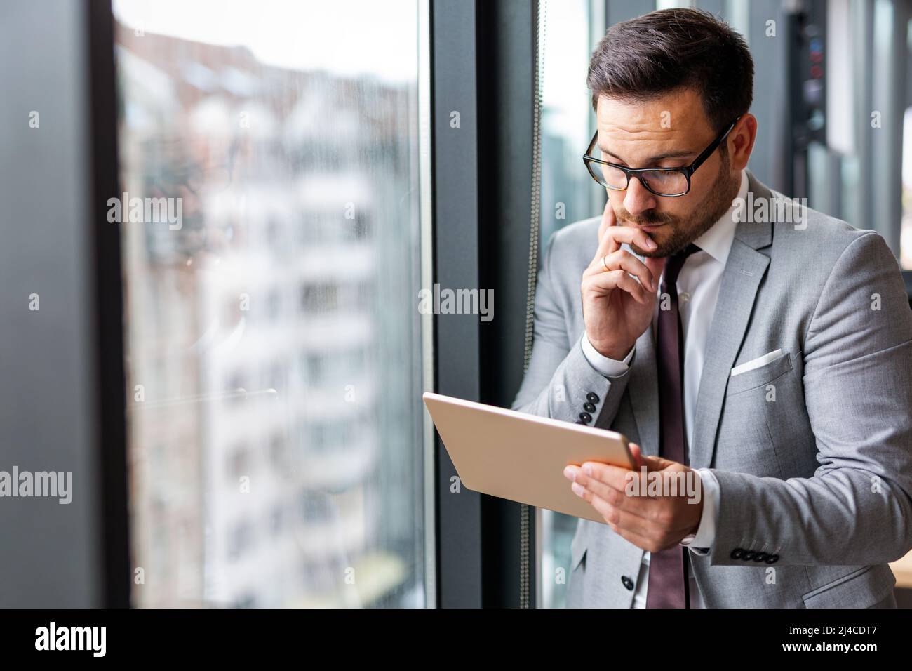 Portrait of frustrated stressed business man working in corporate office Stock Photo