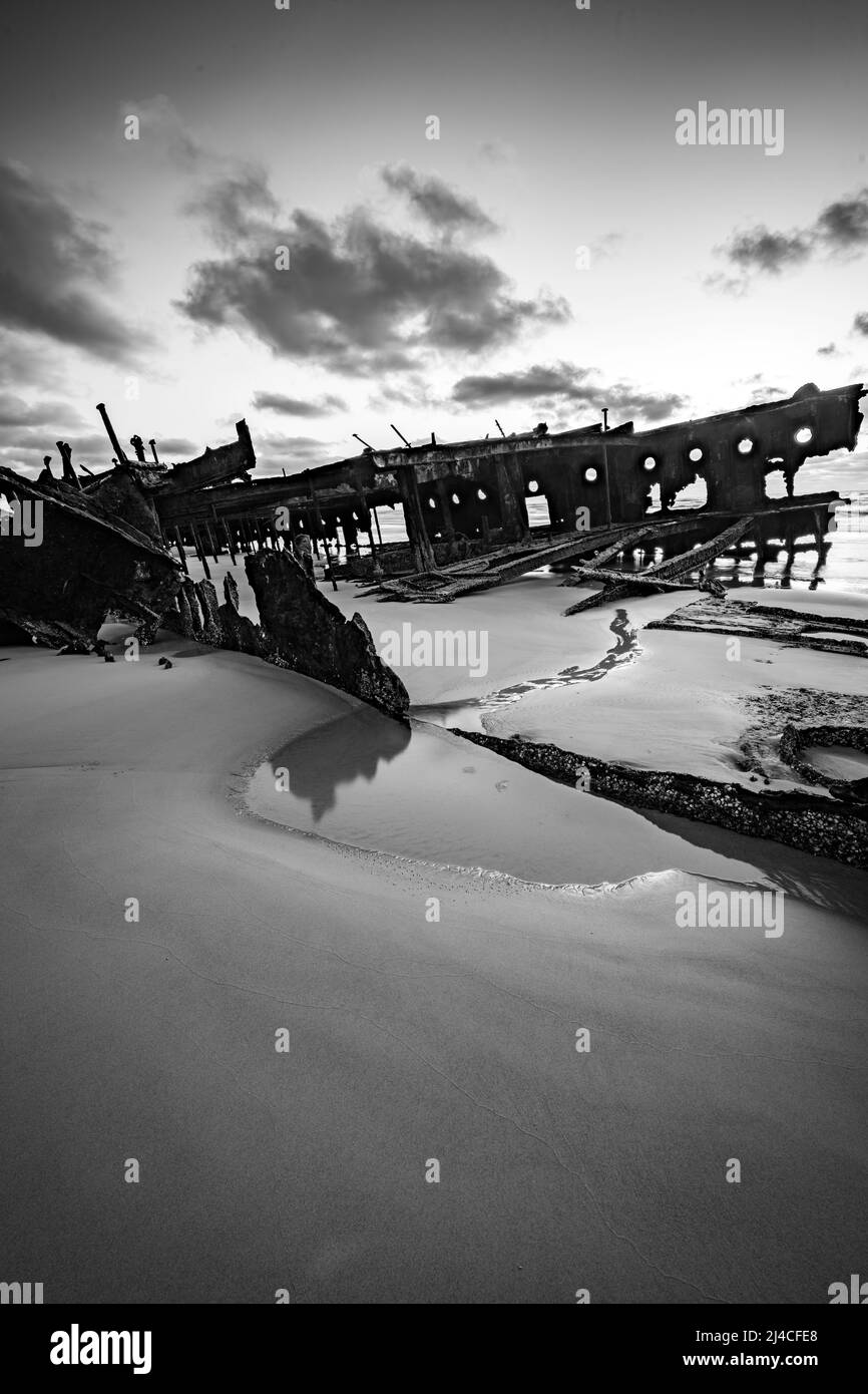 Black and white image of the Maheno shipwreck on Seventy Five Mile Beach on Fraser Island, Queensland, Australia. Stock Photo