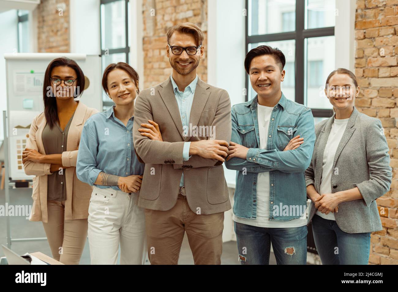 Successful creative business team looking at camera Stock Photo