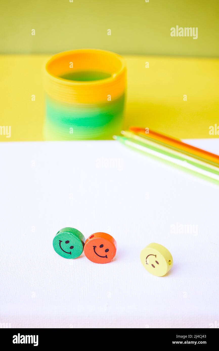Close up of three colorful smiley faces over a white canvas Stock Photo