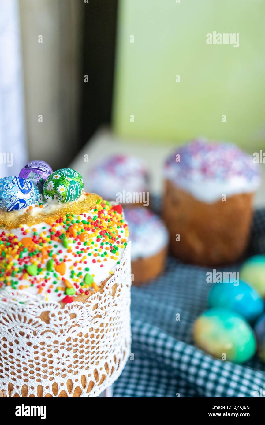 Easter cake with glace icing and colored easter eggs rustic style. Stock Photo