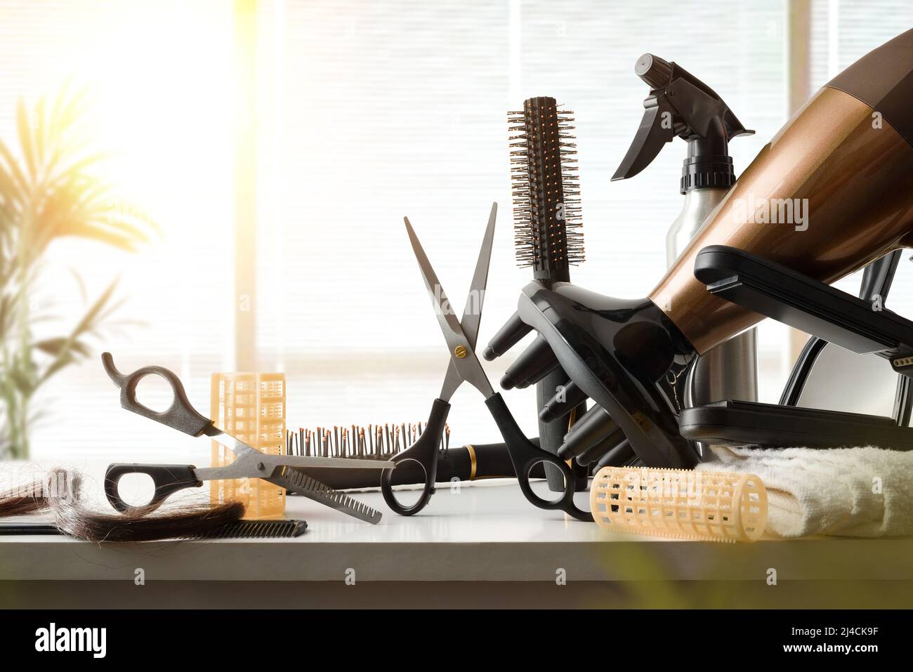 Hairdressing tools on white workbench with window in the background. Front view. Horizontal composition. Stock Photo