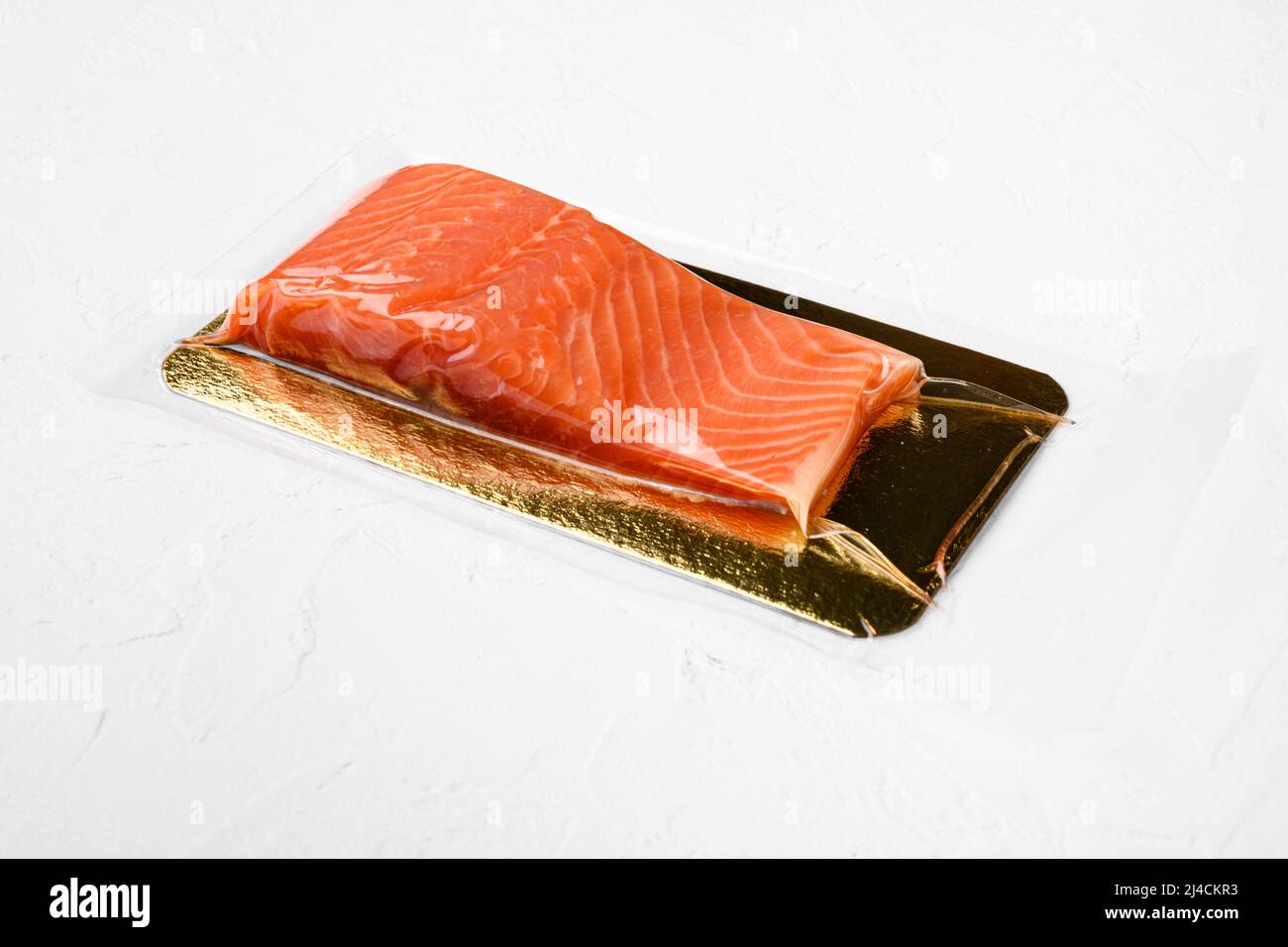 Salmon fillet vacuum pack fish meat set, on white stone table