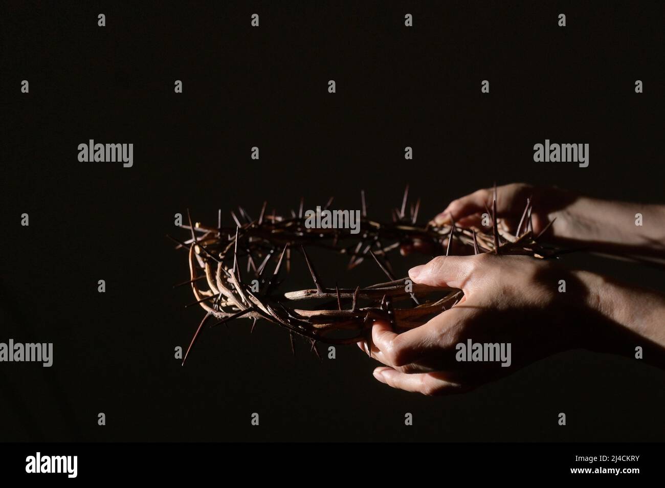 Closeup Crown of thorns in hands and sun rays Stock Photo