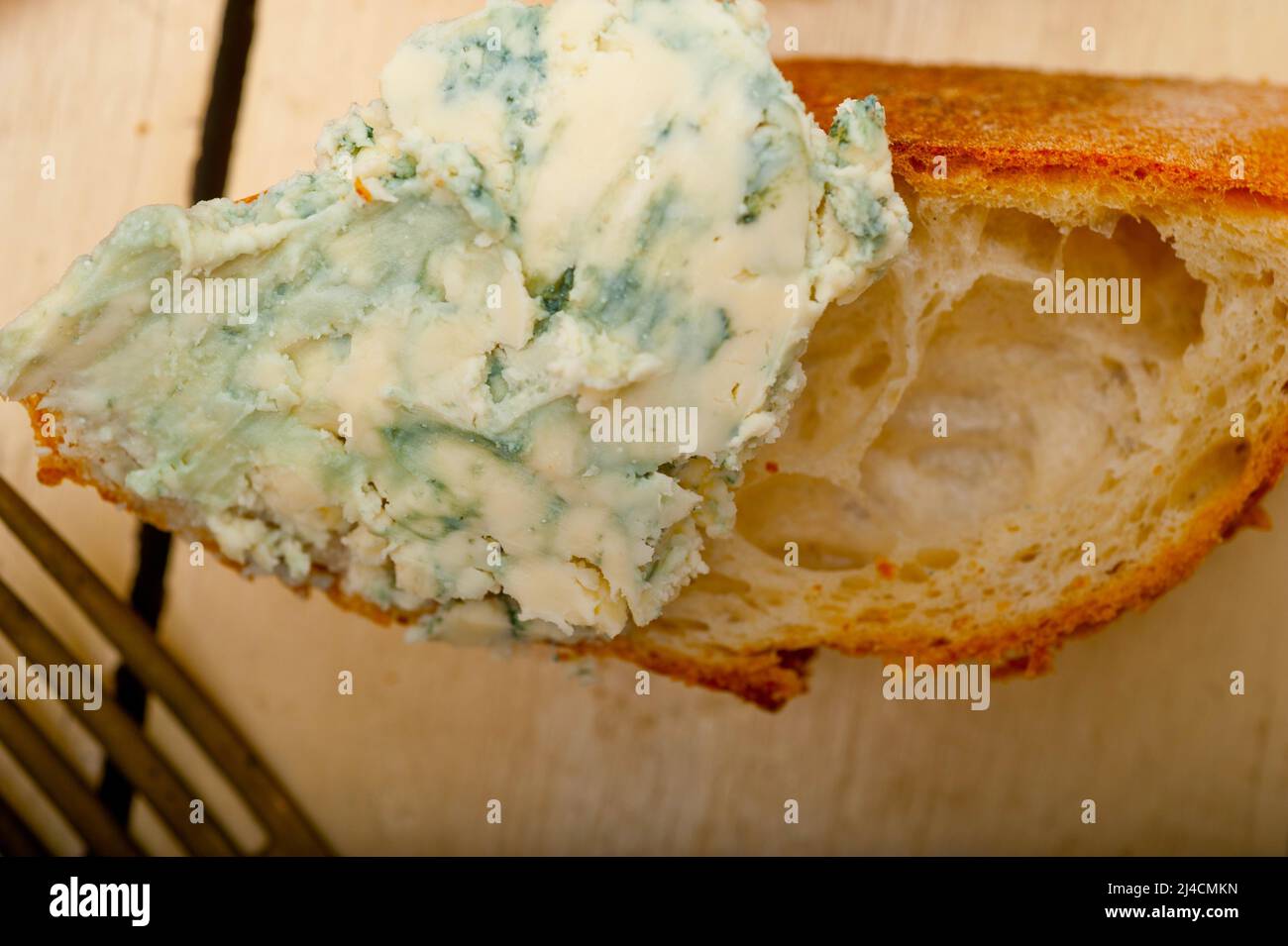 Fresh blue cheese spread ove french baguette with cherry tomatoes on side Stock Photo