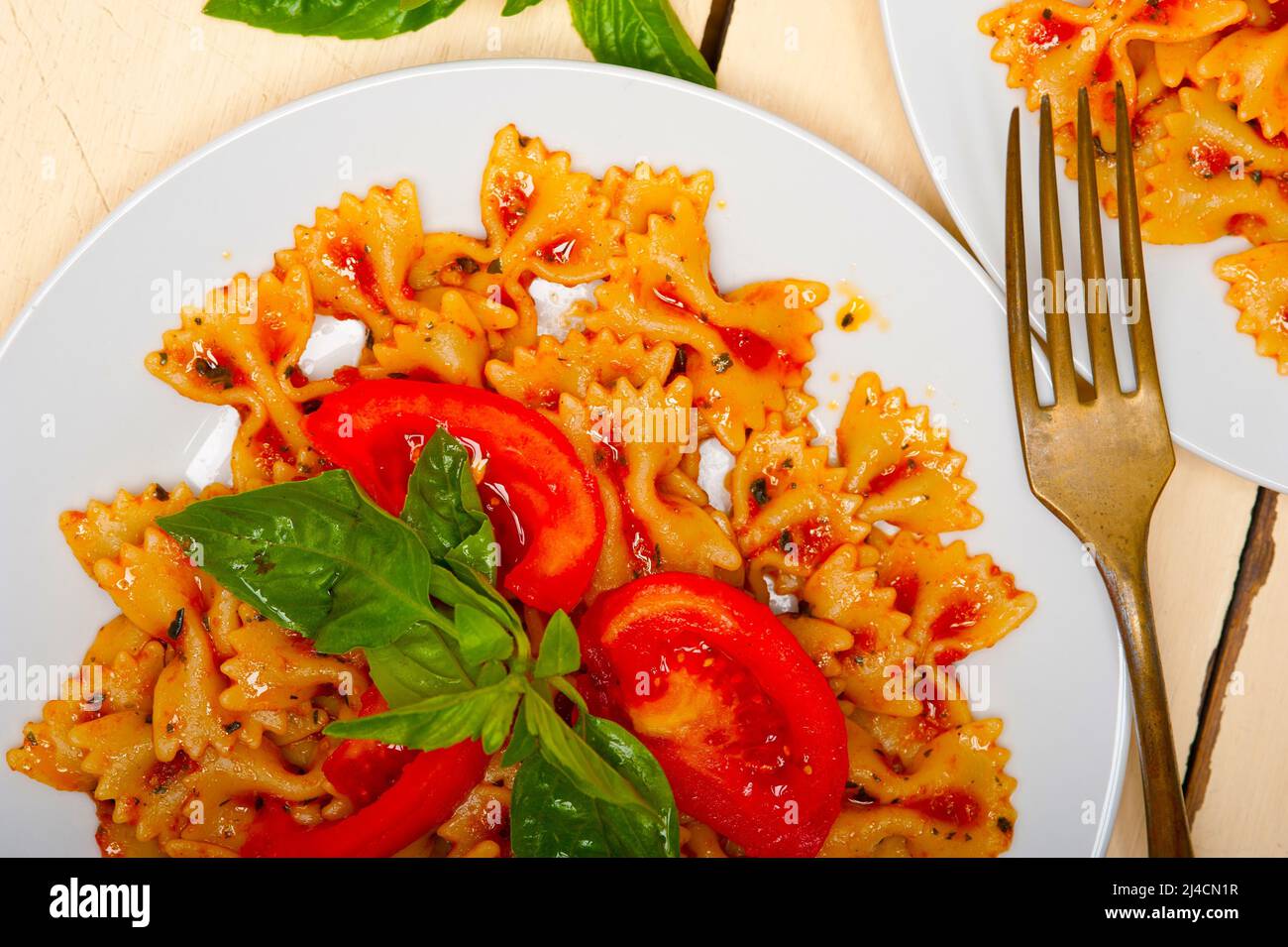 Italian pasta farfalle butterfly bowtie with tomato basil sauce over