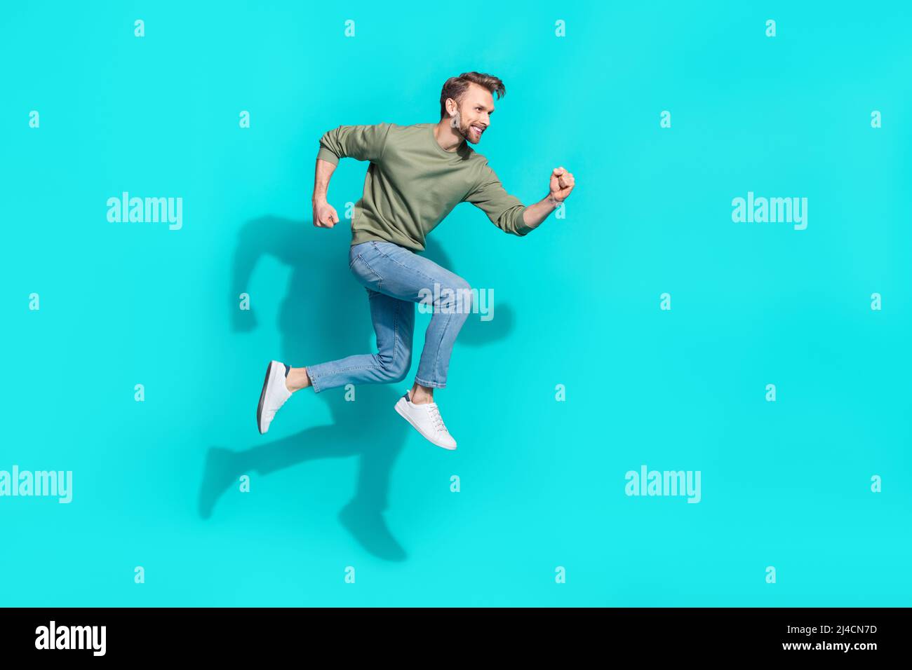 Full length photo of young blond guy run wear sweater jeans sneakers ...