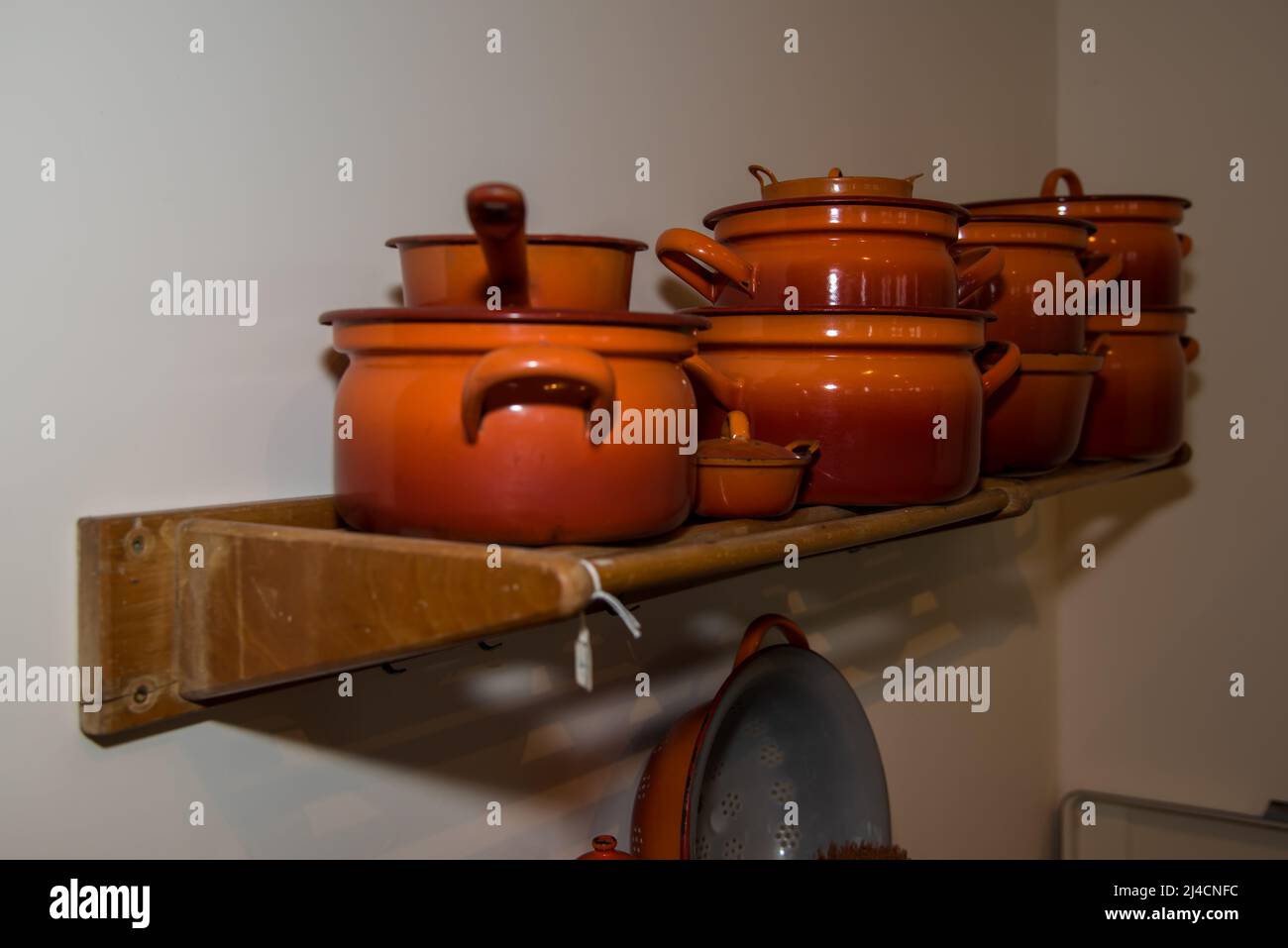 Hoorn, Netherlands, March 2022. Detail from an old Dutch kitchen, a rack of enamel pans. High quality photo Stock Photo