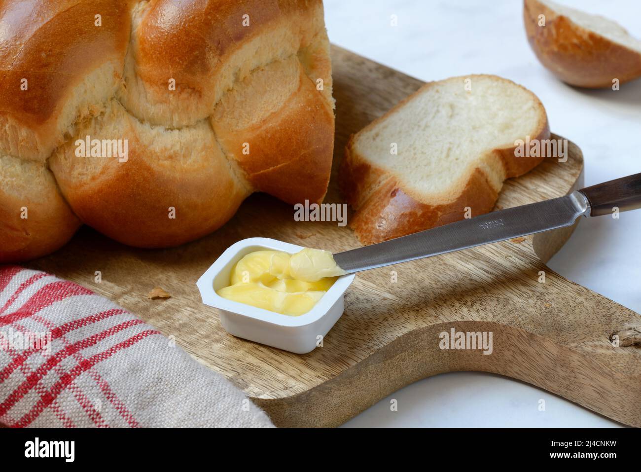 Butter in portion packs and butter plait Stock Photo Alamy