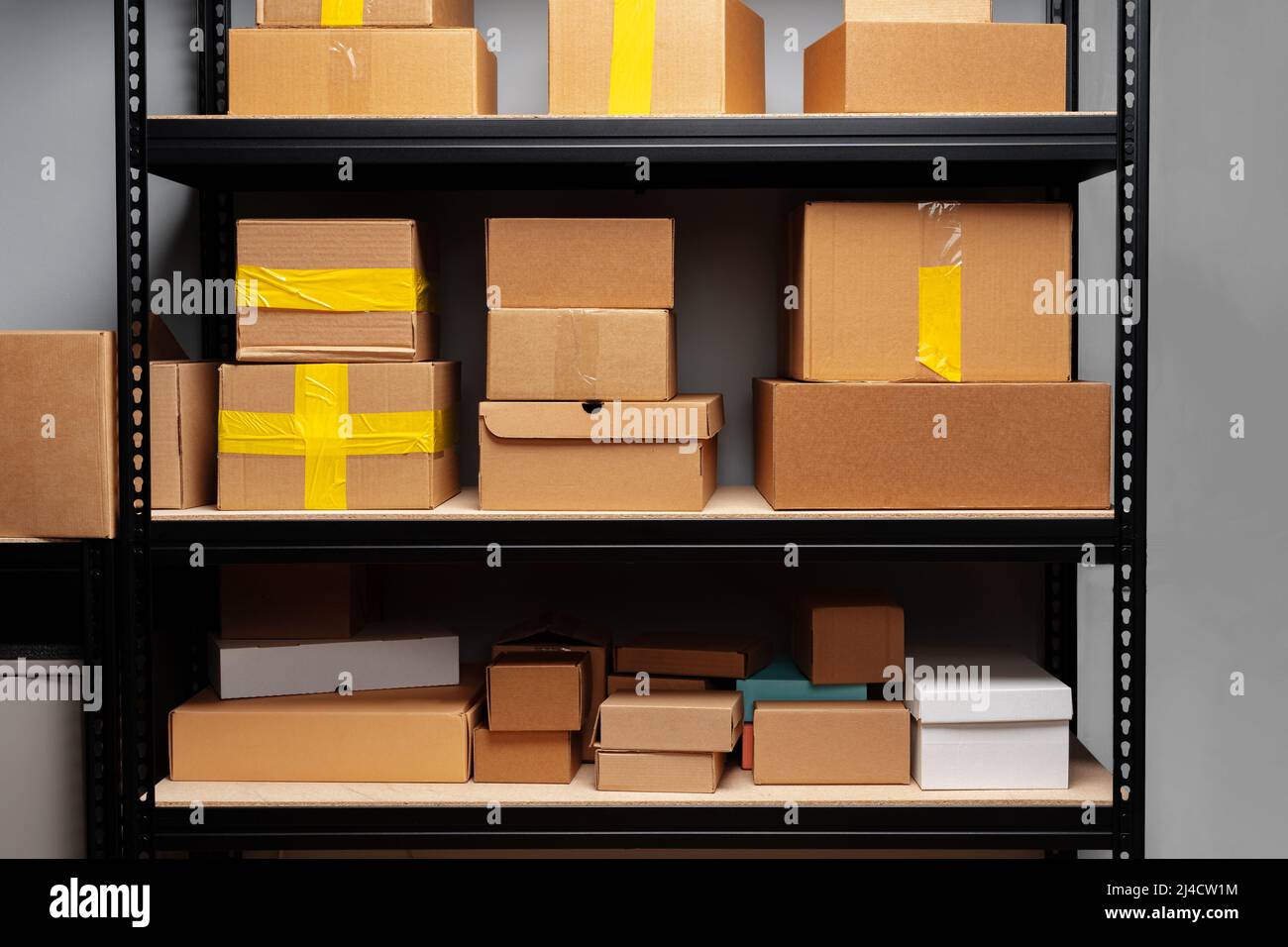 Rack shelves with paper boxes in warehouse Stock Photo - Alamy