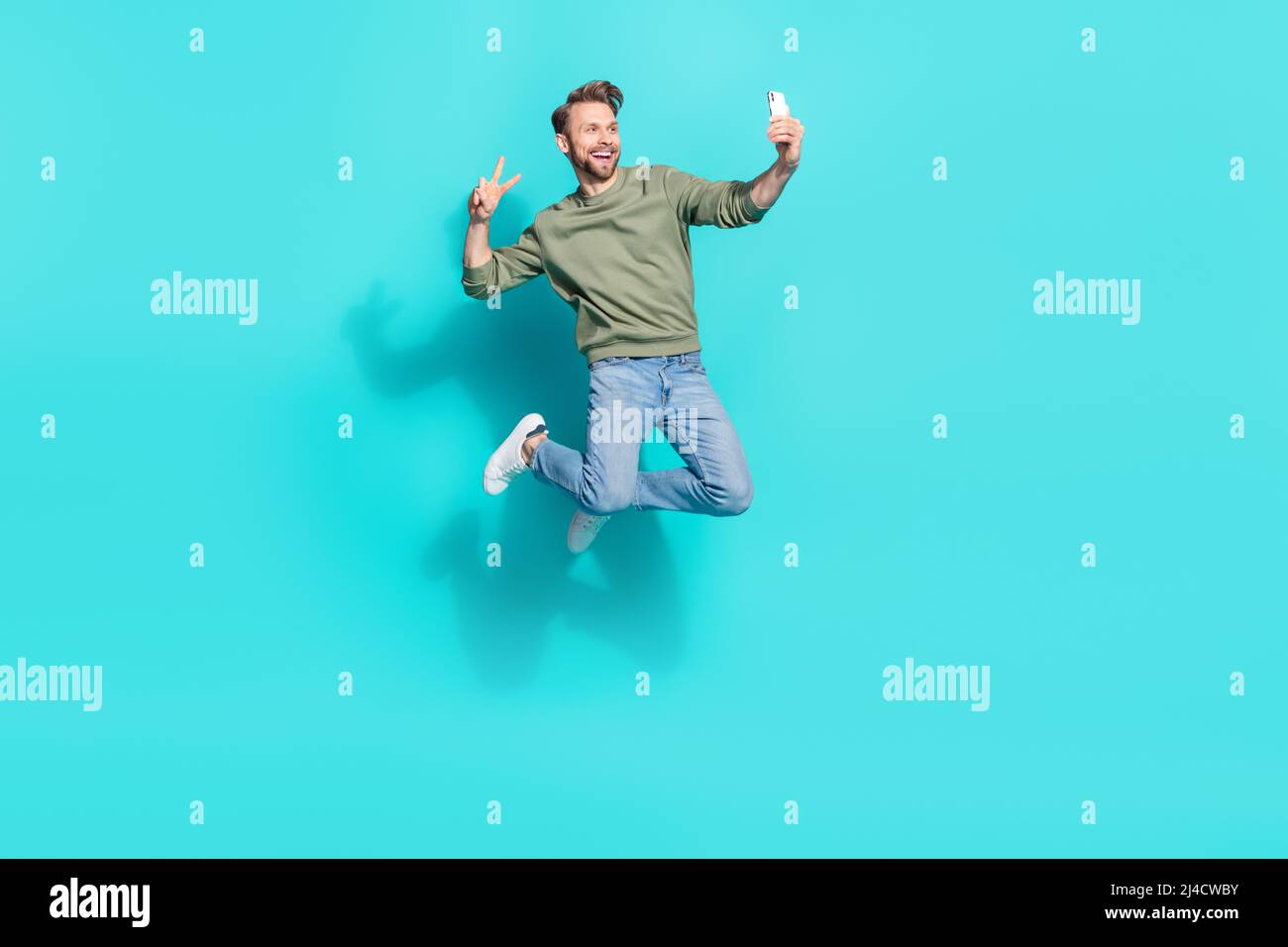 Full length profile photo of crazy blogger man jump hold telephone make ...