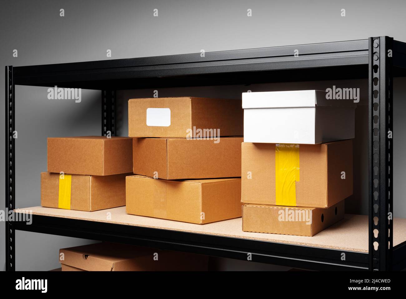 Rows of shelves with cardboard boxes in modern warehouse Stock Photo ...