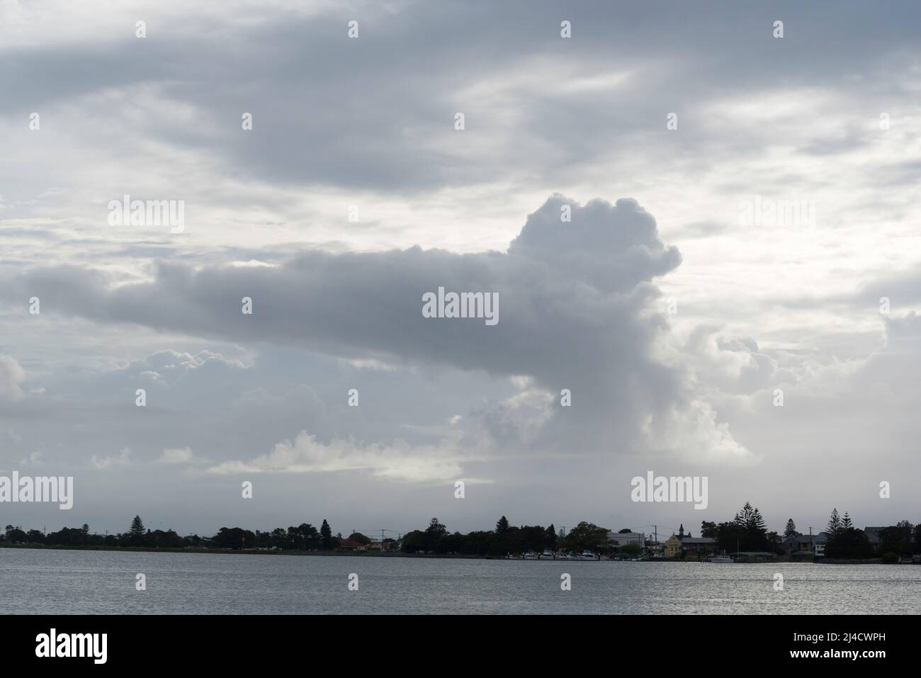 A cumulonimbus incus cloud or anvil cloud is a cumulonimbus cloud that has reached the level of stratospheric stability and has formed a flat top Stock Photo