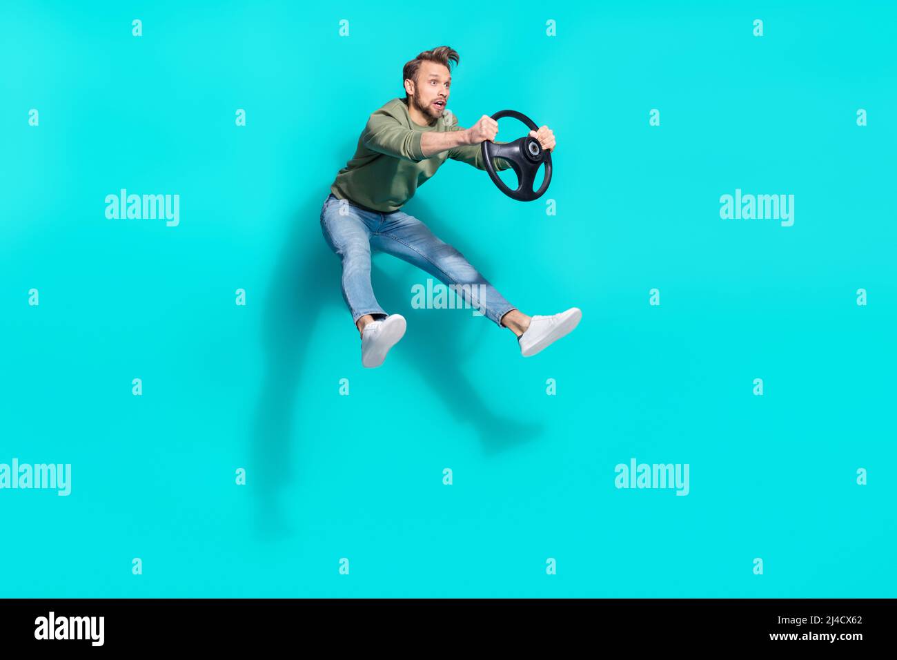 Full length profile photo of funny cheerful driver jump hold steering