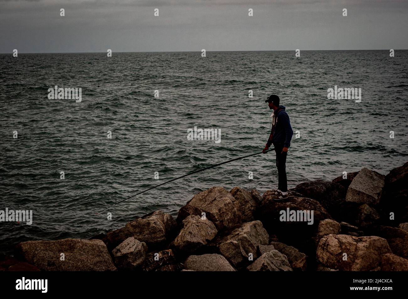 Man fishing in Barcelona Stock Photo