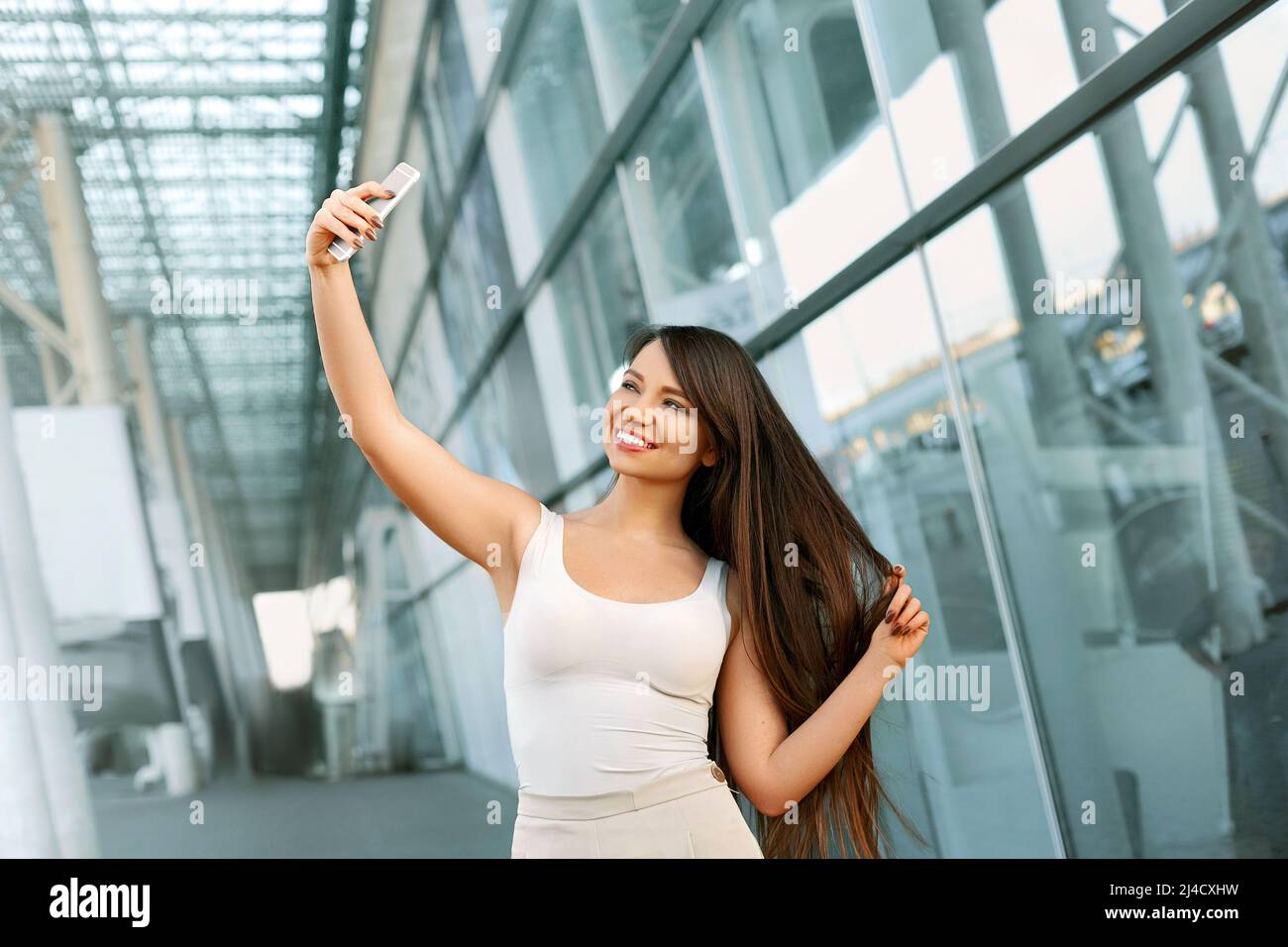 Happy young woman taking selfie. Stock Photo