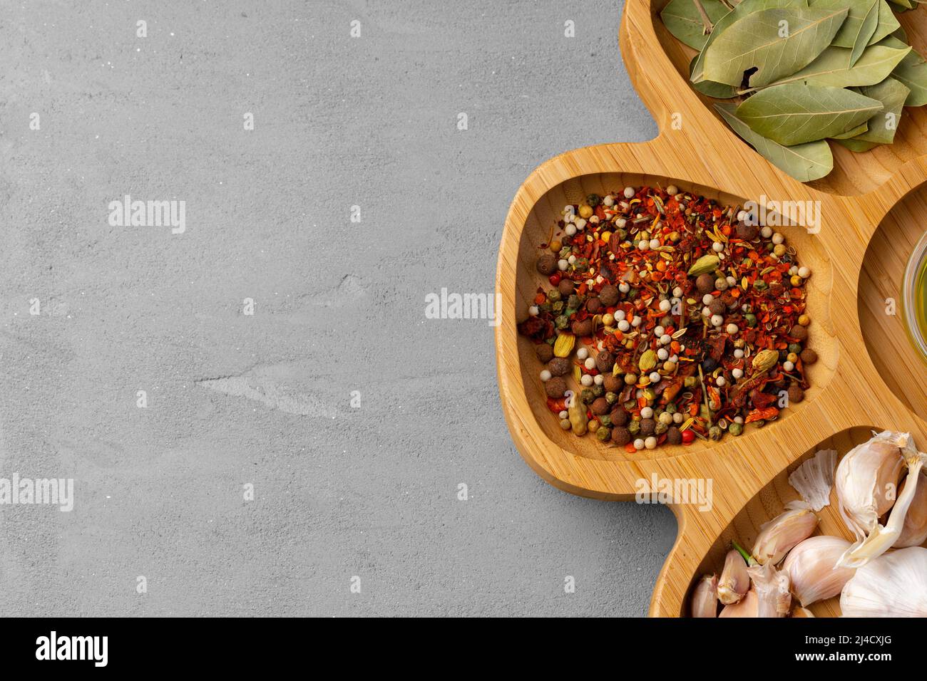 Various spices and herbs on gray background Stock Photo