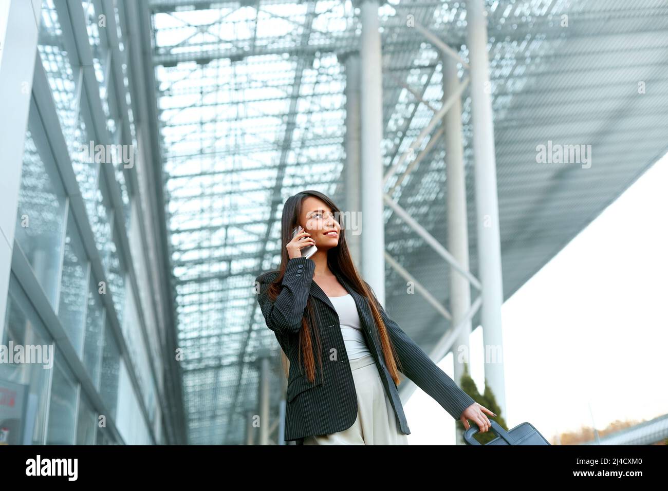 Beautiful Woman Talking On Phone Walking On Street. Portrait Of Business Woman Calling On Mobile Phone Near Office. Stock Photo