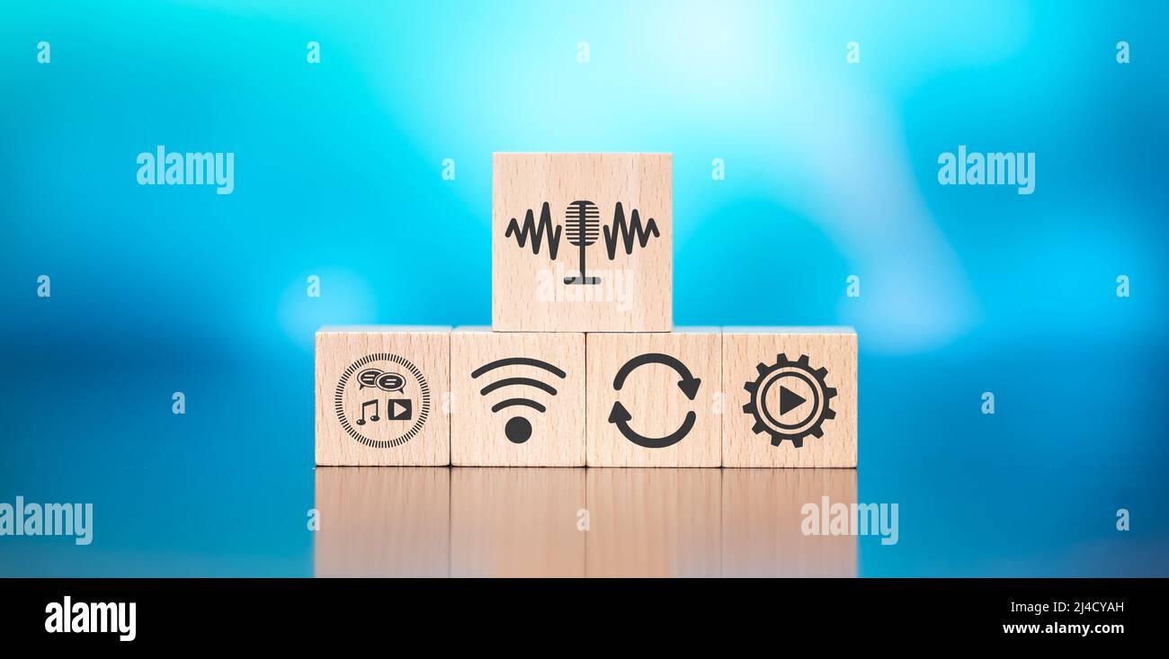 Wooden blocks with symbol of podcast concept on blue background Stock