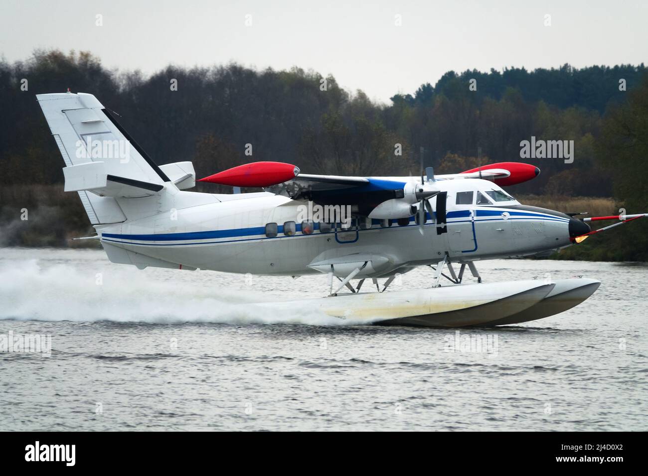 The Twinengine seaplane a seaplane rises from water, from the forest