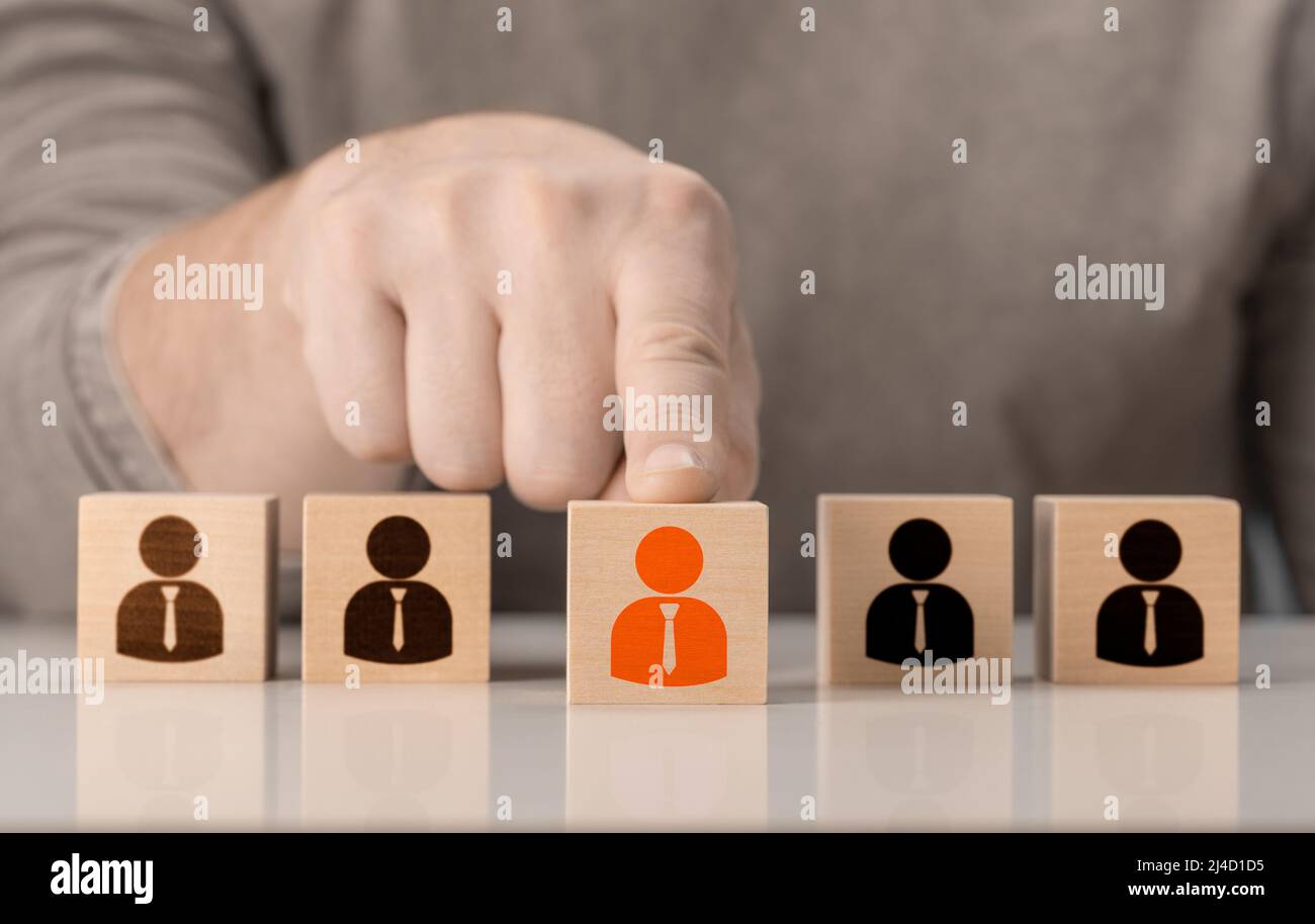 HR, Human resources and team completing. Human Resources and personnel hiring concept. Employees are represented by wooden cubes with icons. Business Stock Photo
