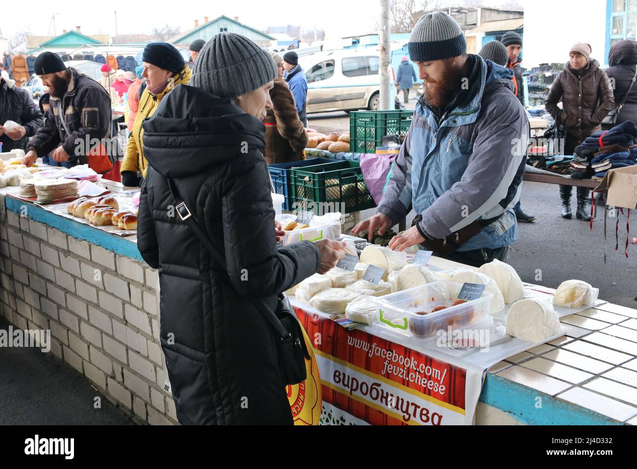 Cherkasy / Ukraine -  Crimean Tatar, a refugee from the Crimea, sells homemade cheese in the Shpola,  center of Ukraine. Stock Photo