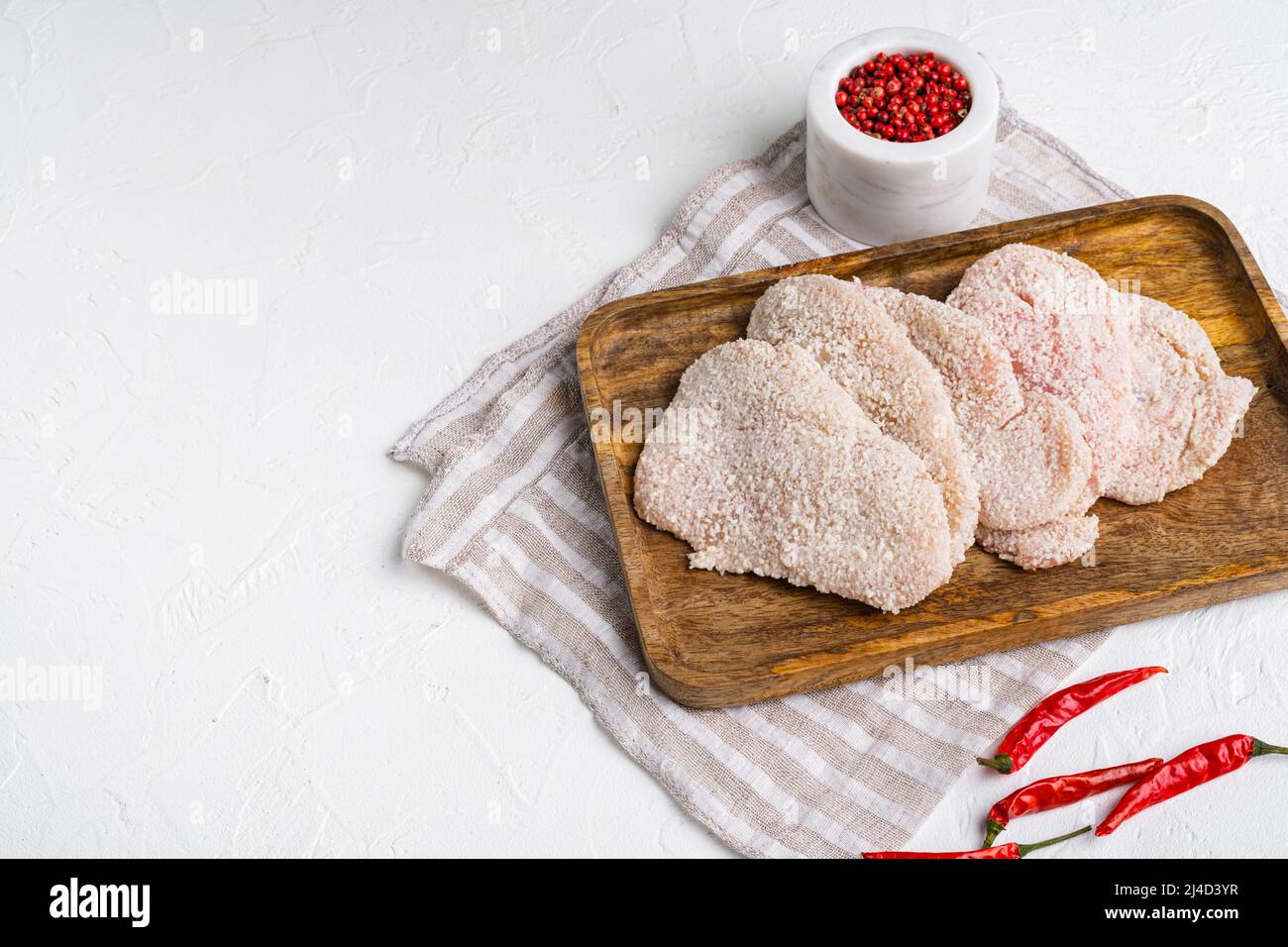 Breaded chicken steak, on white stone table background, top view flat ...