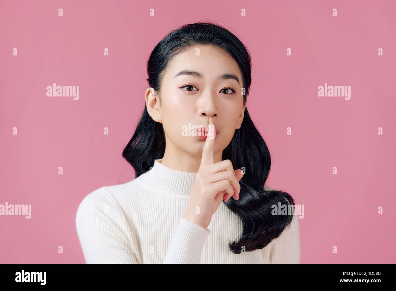 Sassy and creative cute asian girl prepare special surprise for girlfriend say shhh Stock Photo