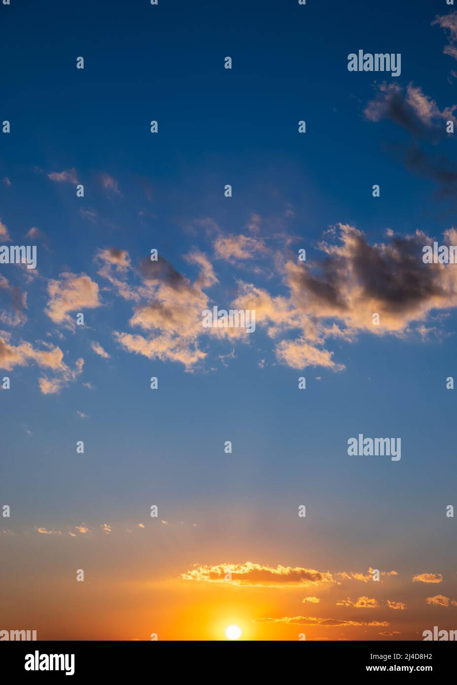 Dramatic sunset sky with orange colored clouds and sun Stock Photo - Alamy