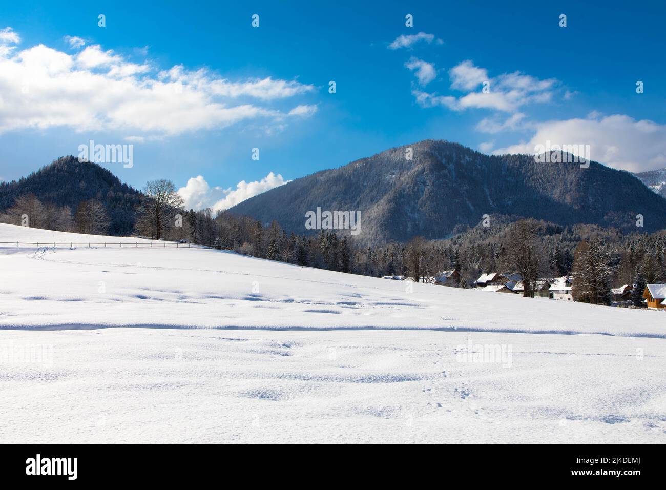 Winter day in austrian alpine ski resort with cloudy sky and bright white snow. Steiermark, Upper Austria Stock Photo