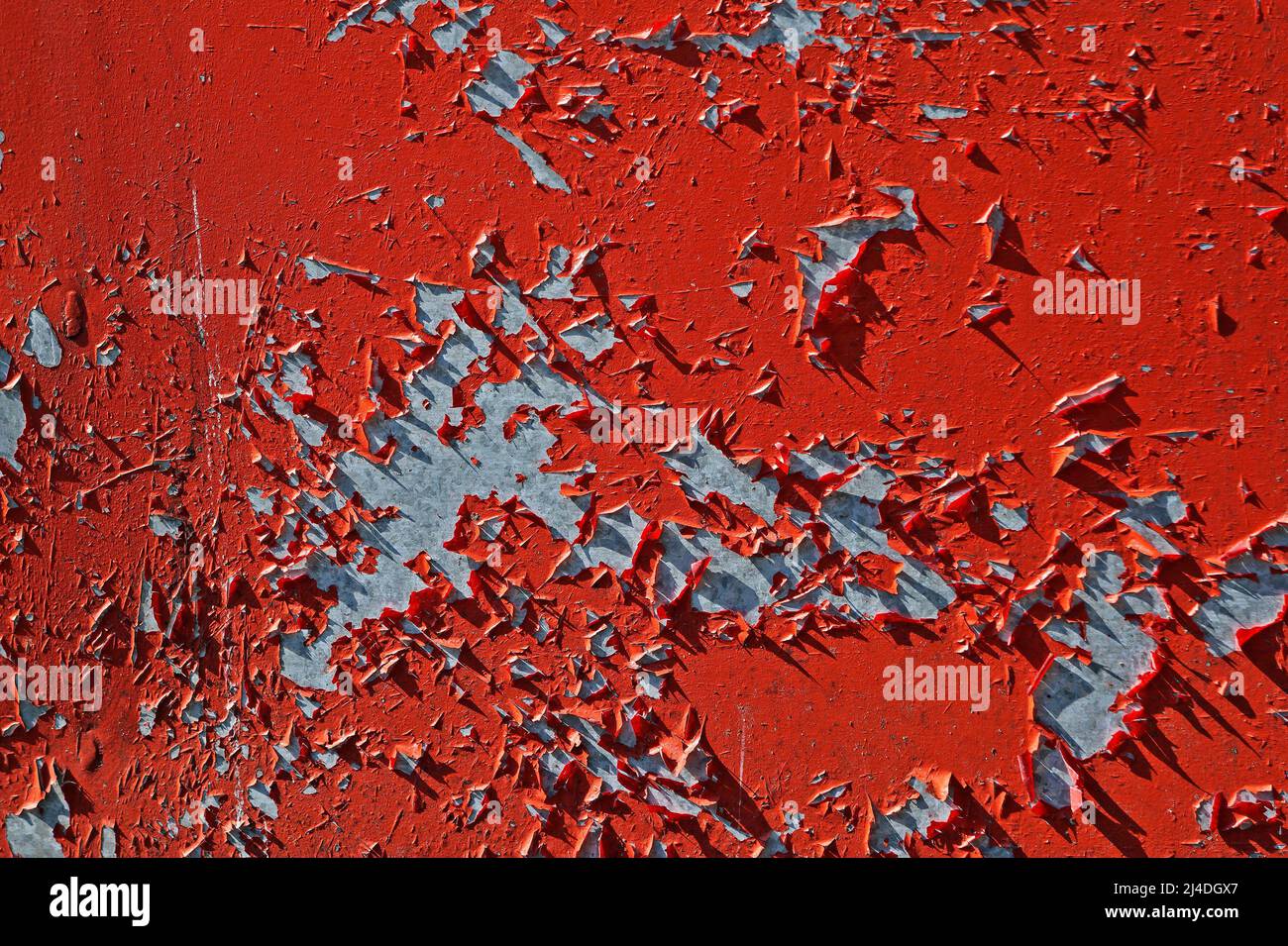 Damaged red metallic surface with peeling paint Stock Photo