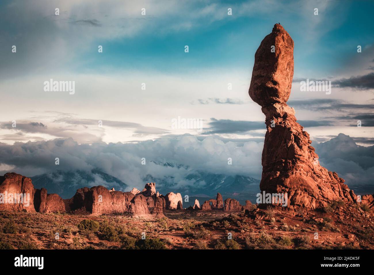 Balance Rock rises out of the rocky desert landscape in Arches National Park, Utah. Stock Photo