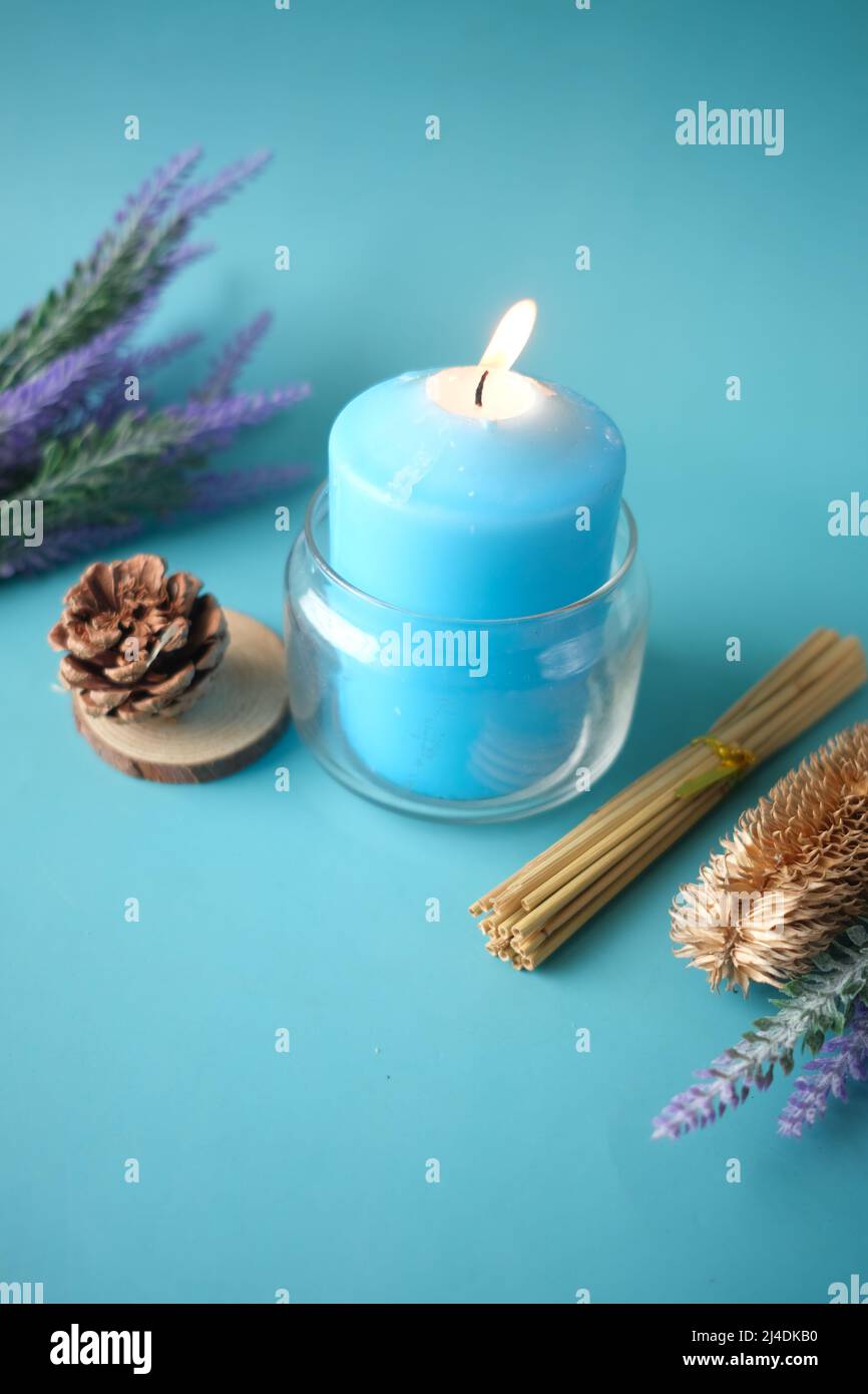 Natural candle in a glass jar and dried flowers on blue Stock Photo Alamy