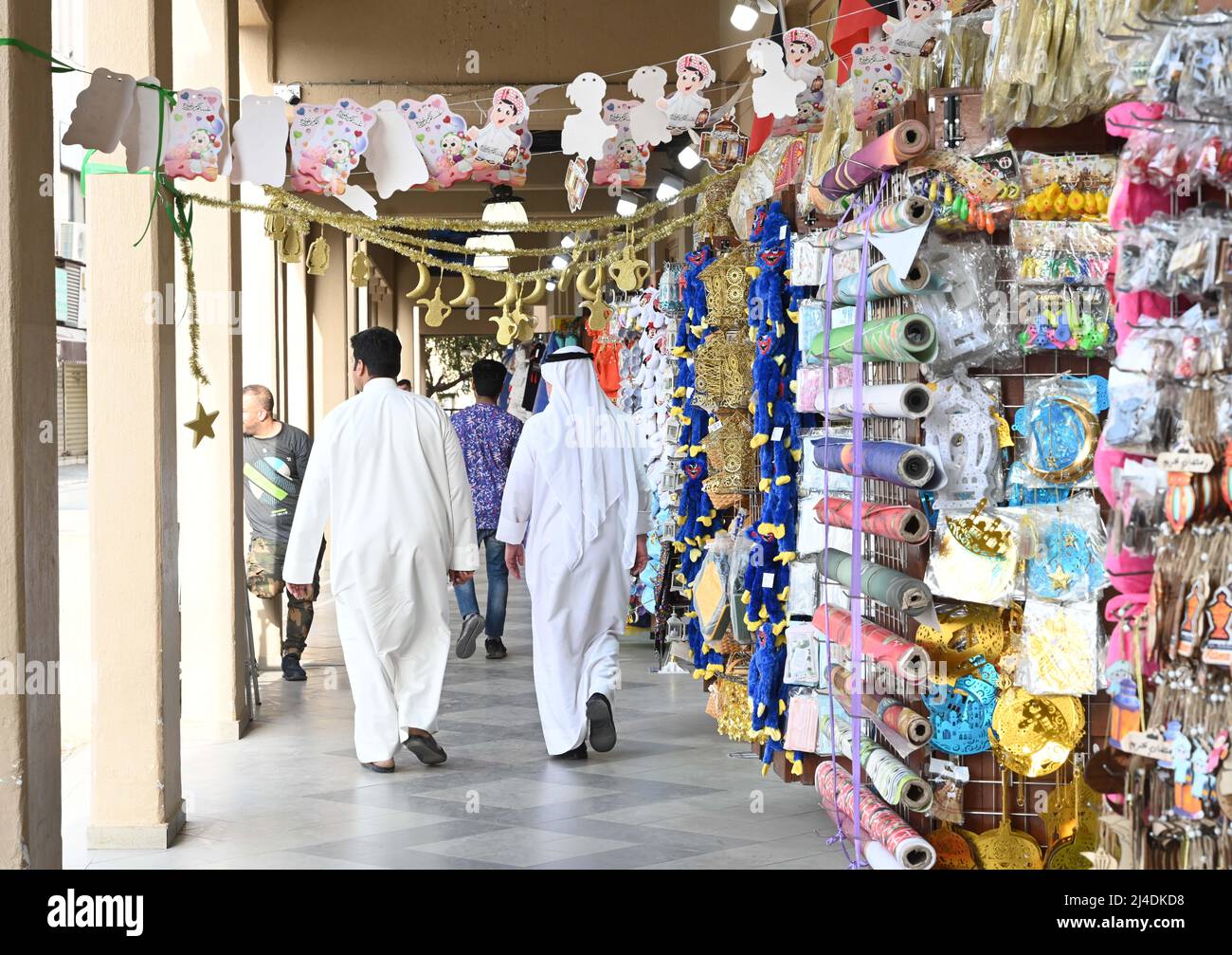 Kuwait City, Kuwait. 14th Apr, 2022. People walk by Ramadan decorations