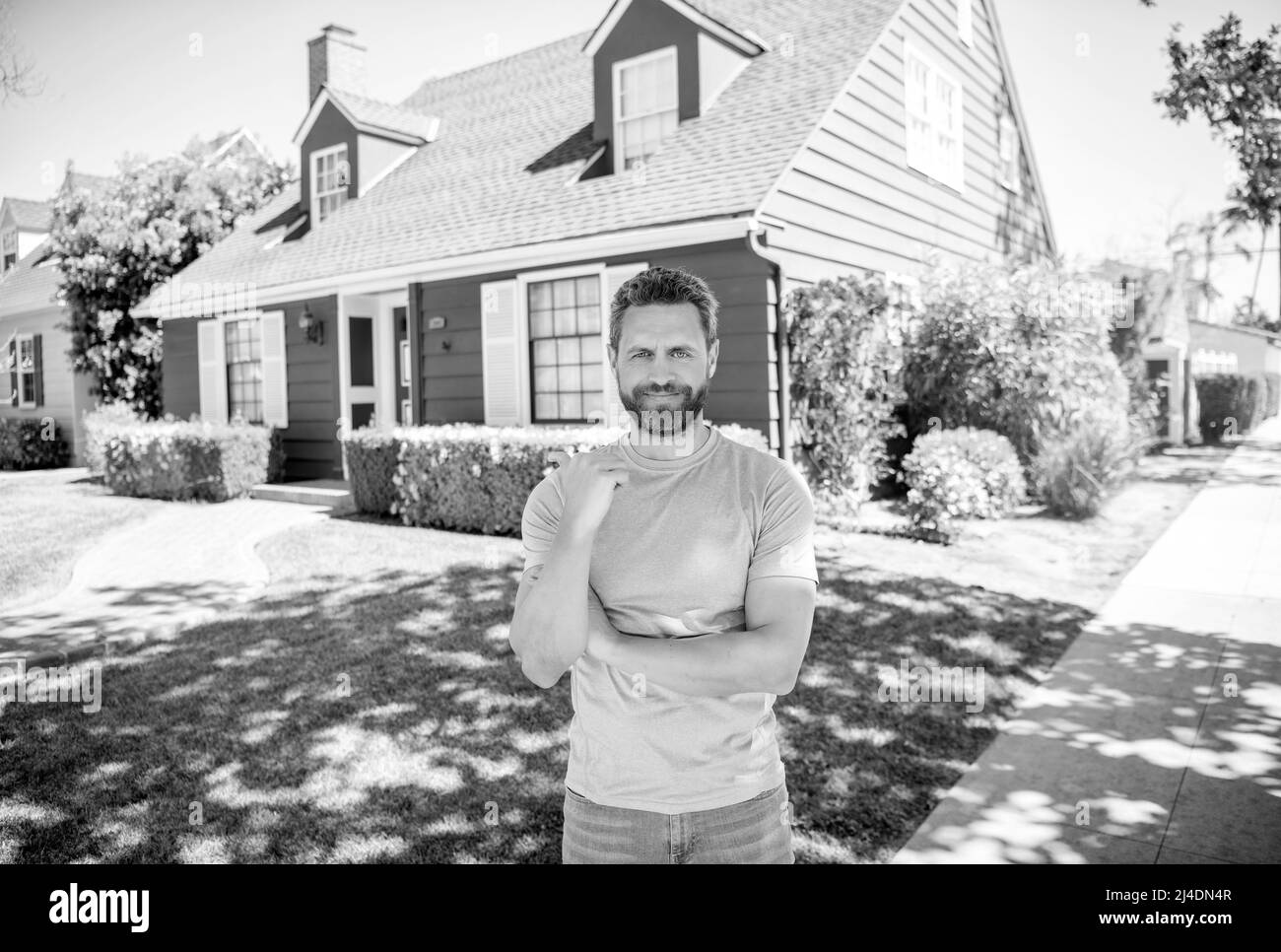 cheerful mature man pointing finger on house, owner Stock Photo Alamy