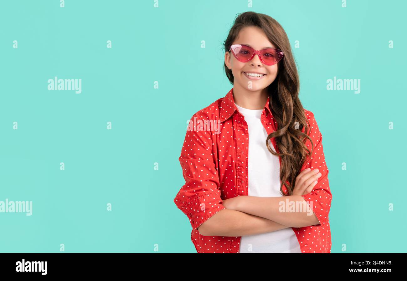express positive emotions. smiling kid with long hair in sunglasses. beauty and fashion. Stock Photo