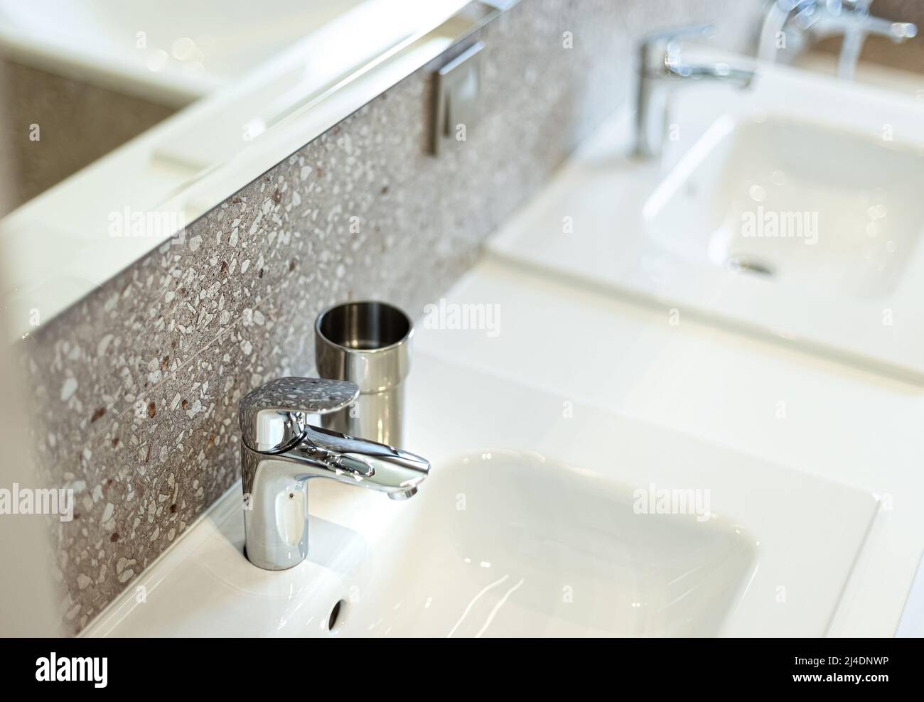 Modern washbasin with chrome faucet (water mixer) close-up. Stock Photo