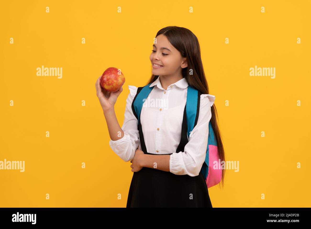 https://c8.alamy.com/comp/2J4DP2B/happy-kid-smile-holding-apple-and-school-bag-yellow-background-back-to-school-2J4DP2B.jpg