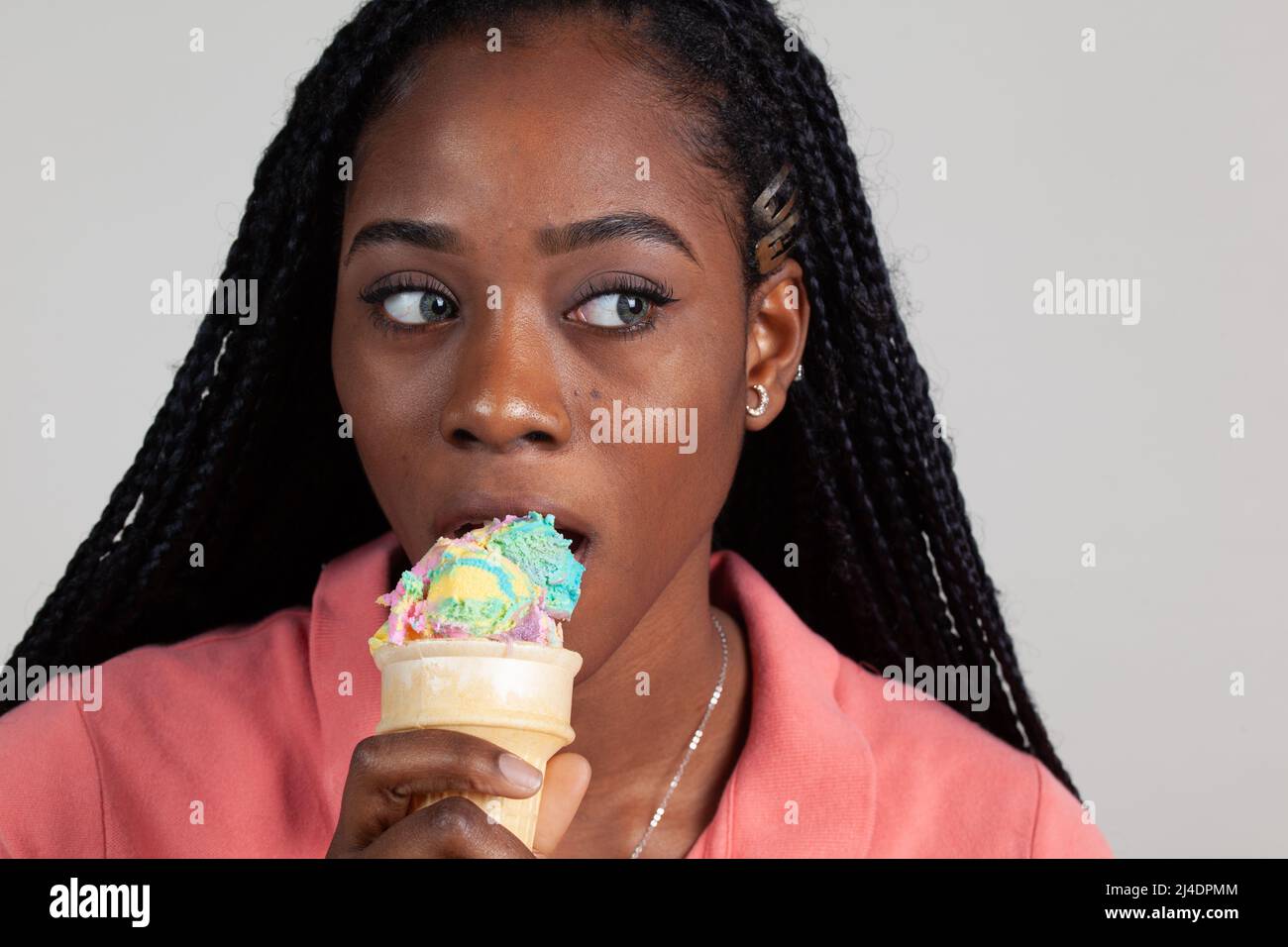 Young Black woman enjoying an ice cream cone Stock Photo