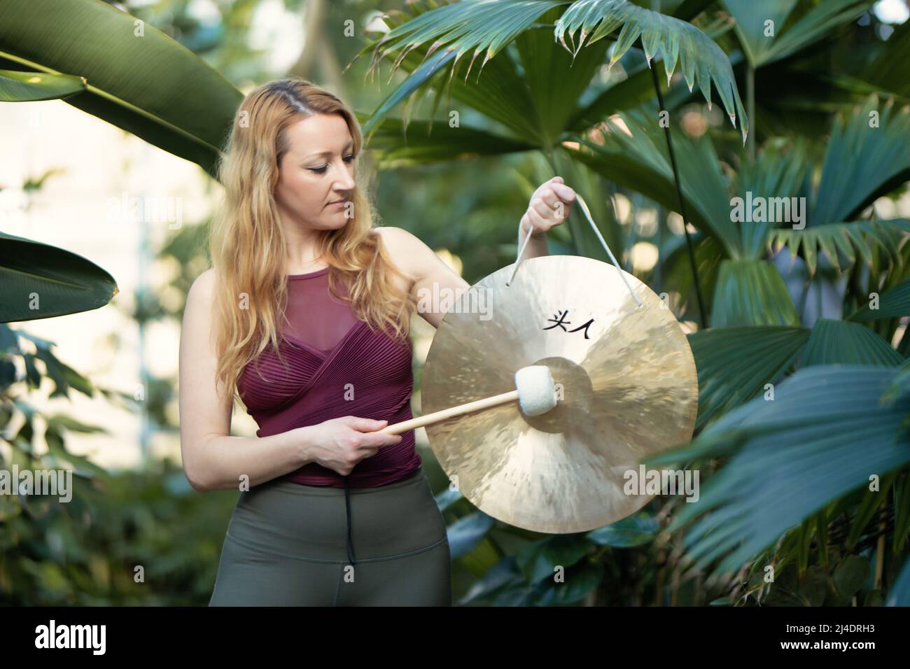 Yoga concept, meditation and sound therapy. Beautiful young caucasian